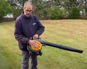 Ken Crowther with a Stiga leaf blower (Model: BL 530) clearing away some autumn leaves.