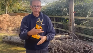 Ken trys out a pair of battery-operated pruning shears.