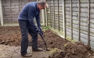 Ken Crowther digging a garden.