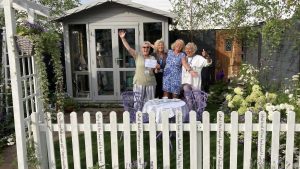 Southport gardening group at Southport Flower Show 2022 with their show garden and medal.
