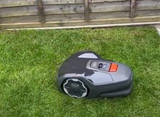 Robot mower from Husqvarna keeps on top of the grass lawn