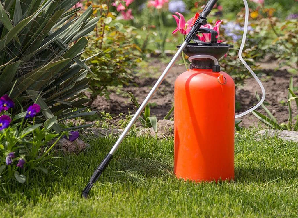 A sprayer on a lawn ready to apply weed killer.